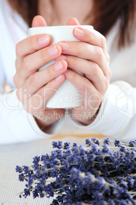 Hands holding a cup