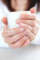 Hands holding a cup