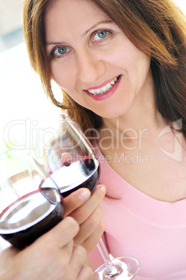 Mature woman toasting with red wine