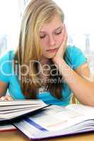 Teenage girl studying with textbooks