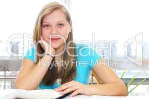 Happy teenage girl studying