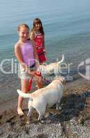 Two girls playing with dogs
