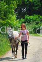 Girl walk pony