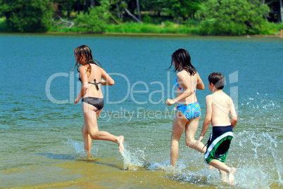 Children running into water