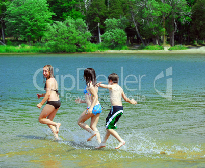 Children running into water
