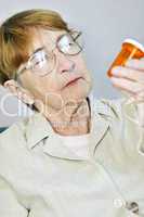 Elderly woman with pill bottle