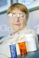 Elderly woman with pill bottles