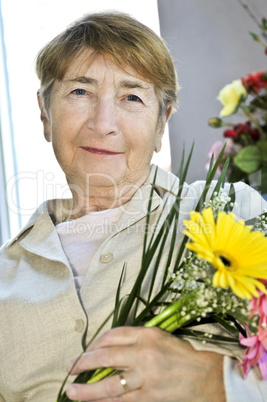 Elderly woman with flowers