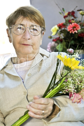 Elderly woman with flowers