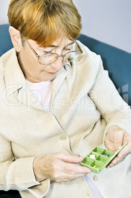Elderly woman with pill box