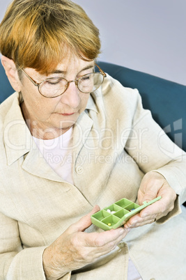 Elderly woman with pill box