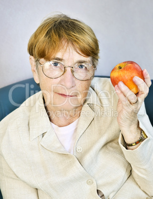 Elderly woman with apple