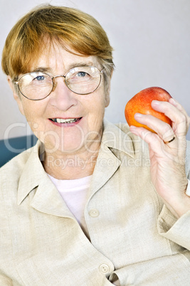 Elderly woman with apple