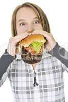 Teenage girl eating big hamburger