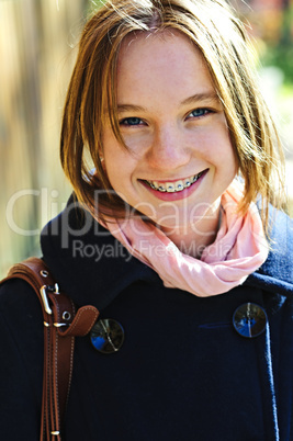 Happy teenage girl in coat