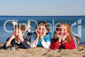 Three children on a beach