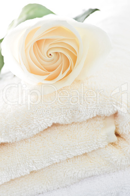 Stack of towels and rose