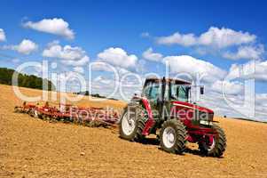 Tractor in plowed field