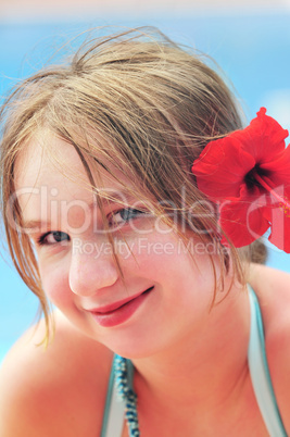 Portrait of a girl with red flower