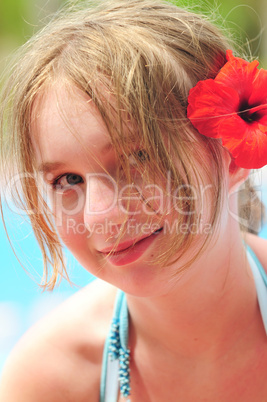 Portrait of a girl with red flower