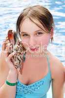Young girl with seashell