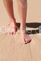 Feet on sandy beach