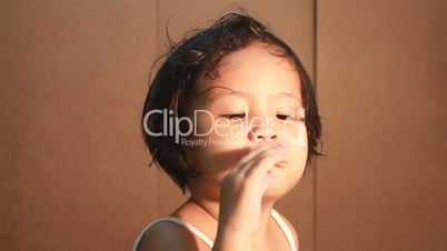 kid enjoying her lollipop