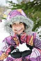 Happy winter girl holding snow