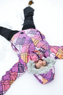 Girl making snow angel