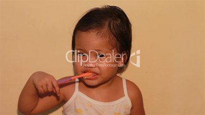Kid enjoying brushing her teeth