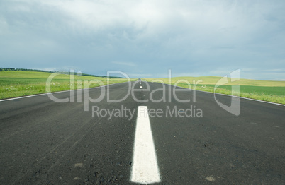 asphalt road in field