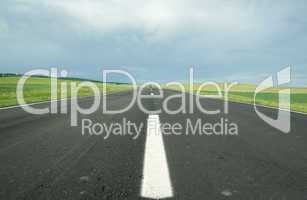 asphalt road in field