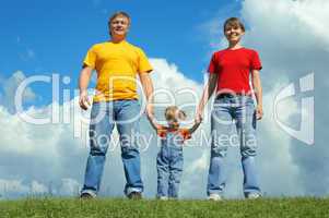happy family stand on green grass under sky