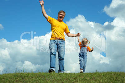 father with daughter on green grass