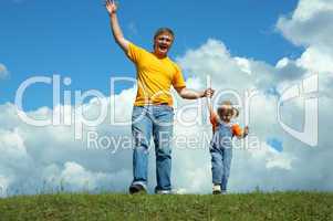 father with daughter on green grass