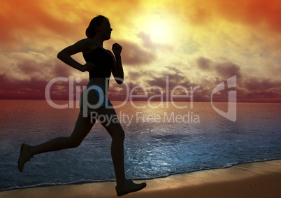 Beautiful young woman running on a beach