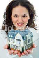 young woman with little house in hand
