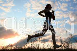 Silhouette woman run under blue sky with clouds