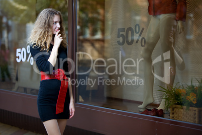 young woman lokk in shop windows