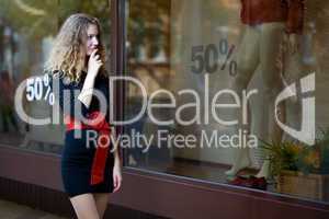 young woman lokk in shop windows