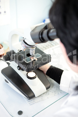 Scientist looking into a microscope