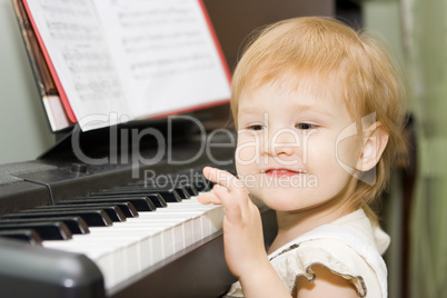 pretty happy child play piano