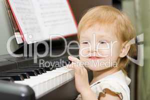 pretty happy child play piano