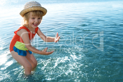 little girl in blue water sea