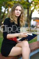 young beauty woman autumn with book