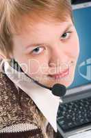 beautiful customer support girl with laptop in headphones and microphone