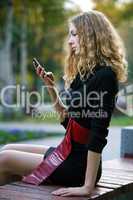 young beauty woman autumn with phone