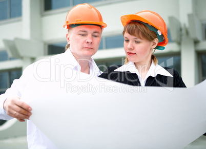 architect man and woman in helmet
