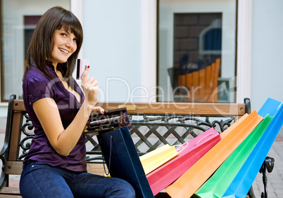 young woman with multi-coloured bags