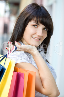 young woman with multi-coloured bags